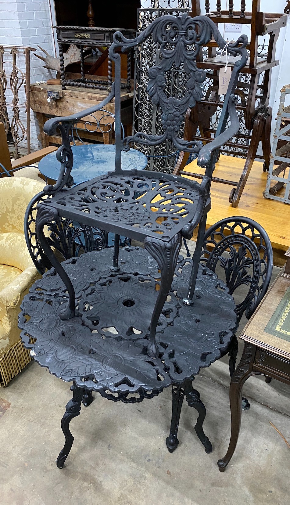 A circular aluminium garden table, diameter 76cm, height 70cm and three aluminium garden chairs